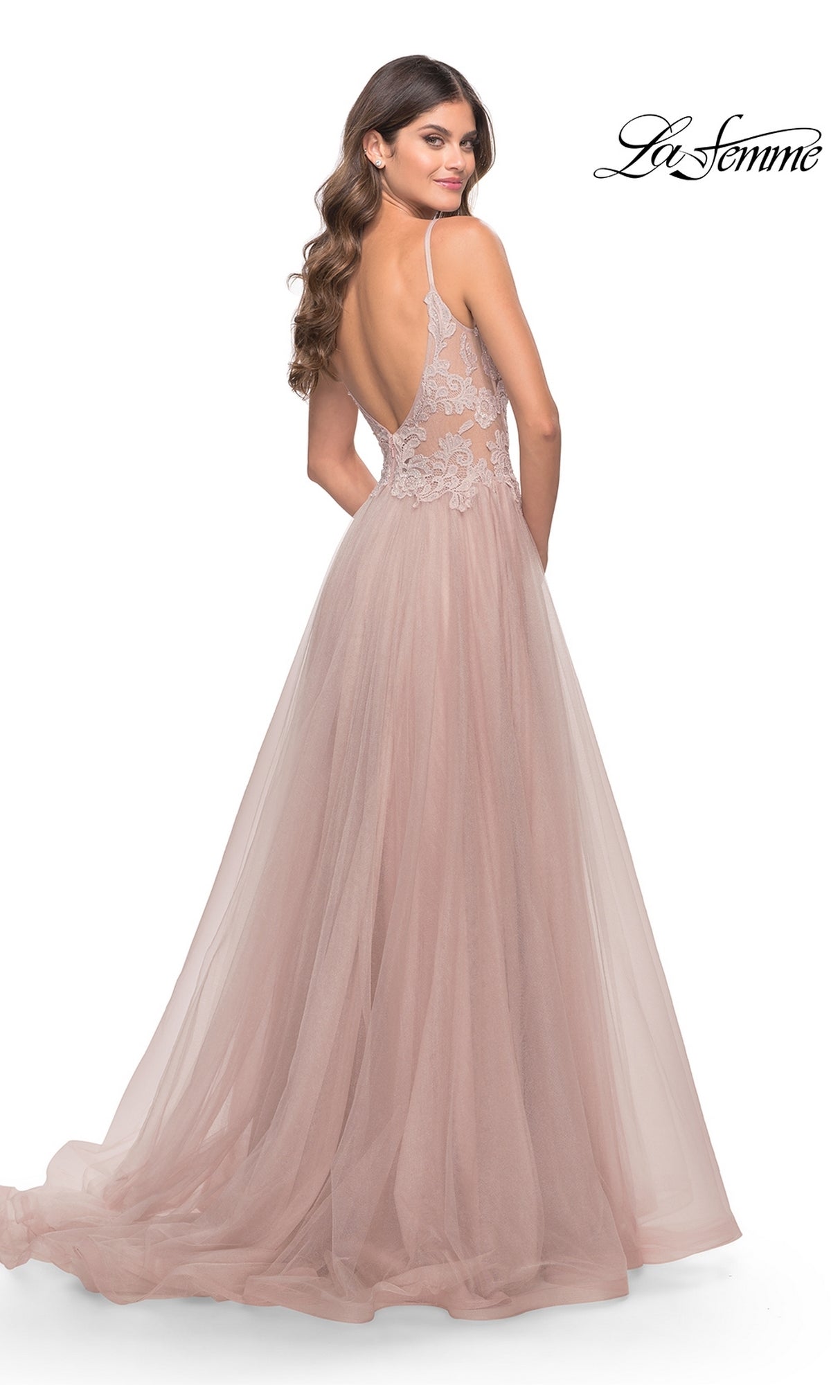 A woman in the La Femme 31507 Lace-Bodice Long Tulle Prom Dress, featuring a blush pink sheer lace bodice, open back, and flowing A-line tulle skirt—an elegant choice for any special night.